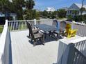 Outdoor deck featuring a table and chairs, perfect for al fresco dining and relaxation at 1001 Palmetto Blvd, Edisto Island, SC 29438