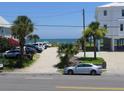 Parking area with palm trees and glimpses of the ocean, a convenient spot to park before hitting the beach at 1001 Palmetto Blvd, Edisto Island, SC 29438