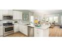 Modern kitchen featuring stainless steel appliances, granite countertops, and hardwood flooring at 1031 Riverbed Retreat Ln, Summerville, SC 29485