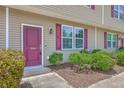A close-up shot of the front door of the townhouse showcasing the entry area and landscaping at 1064 Lexi Ct, Ladson, SC 29456