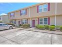 An angled view of the townhouse complex with ample parking and manicured landscaping at 1064 Lexi Ct, Ladson, SC 29456