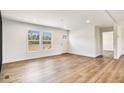 Bright living room featuring light walls, hardwood floors, and a view of trees through the window at 1332 Givhans Rd, Ridgeville, SC 29472