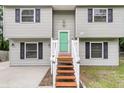 Charming split-level home features a tidy lawn, painted siding, and a bright green front door at 134 Hummingbird Ave, Ladson, SC 29456