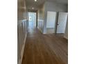 Hallway with wooden floors, white wainscoting, and neutral-toned wallpaper at 140 Baldric Ct, Summerville, SC 29486