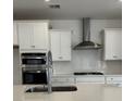 Modern kitchen featuring white cabinets, stainless steel appliances, and a subway tile backsplash at 140 Baldric Ct, Summerville, SC 29486