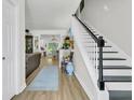 Bright entryway featuring wood floors, a staircase, and an open view to the living spaces at 1682 Camfield Ln, Mount Pleasant, SC 29466