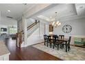 Open-concept dining room with hardwood floors and a view of the staircase at 1722 Trewin Ct, Charleston, SC 29492