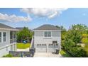 Detached two-car garage with a basketball hoop and an outdoor play area in the backyard at 1722 Trewin Ct, Charleston, SC 29492