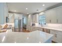 Bright kitchen with white cabinets, stainless steel appliances, subway tile backsplash, and quartz countertops at 2150 Terrabrook Ln, Charleston, SC 29412
