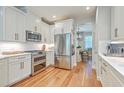 Well-equipped kitchen featuring stainless steel appliances, white cabinets, and hardwood floors at 2150 Terrabrook Ln, Charleston, SC 29412
