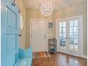 Inviting foyer features a light blue entry bench, coat hooks, hardwood floors and a modern light fixture at 269 Village Stone Cir, Summerville, SC 29483
