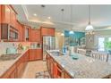 Spacious kitchen features granite countertops, stainless steel appliances, and a large island with seating at 269 Village Stone Cir, Summerville, SC 29483