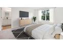 A spacious main bedroom with a large window and hardwood flooring at 2704 Scarlett Maple St, Summerville, SC 29486