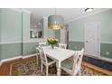 Cozy dining room with a modern light fixture and colorful rug at 2961 Sweetleaf Ln, Johns Island, SC 29455