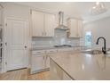 Well-equipped kitchen with grey countertop, stainless hood, white cabinets, and undermount sink at 299 Lucca Dr, Summerville, SC 29486
