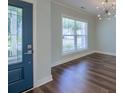 Inviting Foyer with a decorative front door, hardwood floors, and modern light fixture at 3018 Vincent Astor Dr, Johns Island, SC 29455