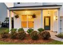 Inviting front porch featuring hanging plants, lush landscaping, and an elegant front door at 3018 Vincent Astor Dr, Johns Island, SC 29455
