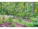 Lush backyard with white picket fence and mature trees, perfect for outdoor entertaining at 3798 Sawmill Ct, Mount Pleasant, SC 29429