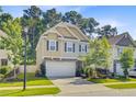 Beautiful view of a charming two-story home with a two-car garage and nicely landscaped front yard at 3798 Sawmill Ct, Mount Pleasant, SC 29429