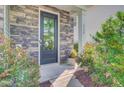 Inviting front door with stone accents and colorful plants, and address 3798 at 3798 Sawmill Ct, Mount Pleasant, SC 29429