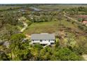 Aerial shot of a charming home nestled amongst lush trees near a tranquil marsh in a beautiful setting at 3810 Marshfield Rd, Johns Island, SC 29455