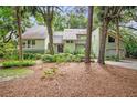 Beautiful exterior featuring a lush, wooded homesite and mature trees adding charm at 40 Greensward Rd, Kiawah Island, SC 29455
