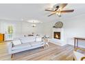 Bright living room featuring a cozy fireplace and modern ceiling fan at 400 Black Oak Rd, Bonneau, SC 29431
