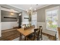 Bright dining area featuring a wooden table, chandelier, and view to the exterior at 423 Sanctuary Park Dr, Summerville, SC 29486