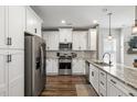 Modern kitchen with white cabinets, stainless steel appliances, and granite countertops at 423 Sanctuary Park Dr, Summerville, SC 29486