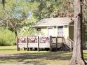 Charming cottage featuring a quaint porch with festive decorations and a cozy ambiance at 4589 Prices Bridge Ln, Walterboro, SC 29488