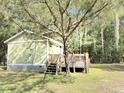 Charming home exterior with a well-maintained lawn and a spacious deck perfect for relaxing at 4589 Prices Bridge Ln, Walterboro, SC 29488