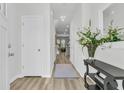 Inviting entryway with light wood floors, white doors, a decorative console table, and a mirror at 493 Trotters Ln, Moncks Corner, SC 29461