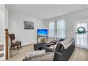 Cozy living room with a comfortable sectional, modern entertainment center, and large windows at 493 Trotters Ln, Moncks Corner, SC 29461