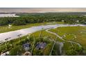 Aerial view showcases a waterfront property with private dock, and lush surroundings at 510 Traders Aly, Mount Pleasant, SC 29464
