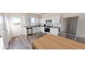 Eat-in kitchen with stainless steel appliances, white cabinets, and a view to the backyard at 5306 Bending Flats Way, Summerville, SC 29485