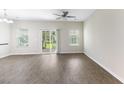 Bright, airy living room with modern floors and sliding glass door to patio at 540 Truman Dr, Goose Creek, SC 29445