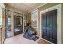 Enclosed porch featuring a covered grill and tiled flooring near the home's entrance at 8327 Childs Cove Cir, North Charleston, SC 29418