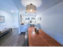 Open-concept living space with dining table that leads into a bright modern kitchen featuring white cabinets at 837 Club Cottage Rd, Edisto Island, SC 29438