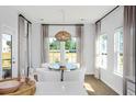 Bright breakfast nook with white chairs, round table, and stylish lighting fixture at 1027 Riverbed Retreat Ln, Summerville, SC 29483