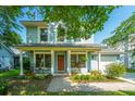 Charming two-story home with a welcoming front porch, landscaped yard, and inviting curb appeal at 103 Toura Ln, Charleston, SC 29414