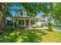 Charming two-story home with a welcoming front porch, landscaped yard, and inviting curb appeal at 103 Toura Ln, Charleston, SC 29414