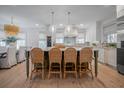 Open-concept kitchen with a large island, wicker chairs, and decorative pendant lighting at 108 Live Oak Dr, Mount Pleasant, SC 29464