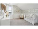 Bedroom with charming wallpaper, plush carpet, and a cozy chair at 109 Orchard Blossom Ln, Summerville, SC 29485