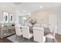 Elegant dining room with seating for six, stylish furnishings, and a view of the staircase at 118 Orchard Blossom Ln, Summerville, SC 29485