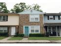 A well-maintained townhome showcases a brick exterior, complemented by tidy landscaping and individual character at 124 Brush Blvd, Goose Creek, SC 29445