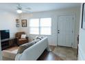 Bright living room featuring a comfortable couch, leather chair, and plenty of natural light at 124 Brush Blvd, Goose Creek, SC 29445