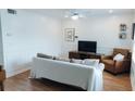 The cozy living room showcases wood floors and plush seating, perfect for relaxation and entertainment at 124 Brush Blvd, Goose Creek, SC 29445
