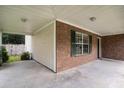 Spacious covered porch featuring brick accents and a concrete floor at 133 Guildford Dr, Goose Creek, SC 29445