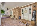 Welcoming front porch with brick flooring, ceiling fan, swing, and decorative touches create a cozy outdoor space at 138 Brant Acres Ln, Bonneau, SC 29431