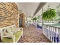 Spacious covered porch with brick flooring, comfortable seating, and a charming view of the front yard at 138 Brant Acres Ln, Bonneau, SC 29431
